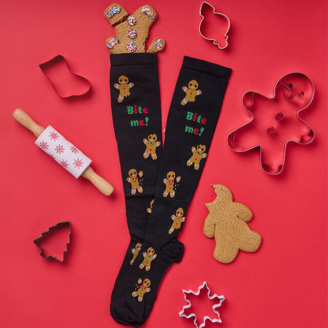 Compression Socks in Bite me (cookie print) surrounded by cookies.